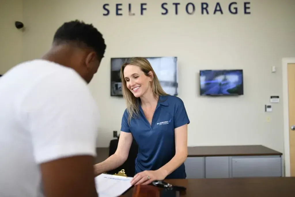 Bluebird staff member helping customer at counter.