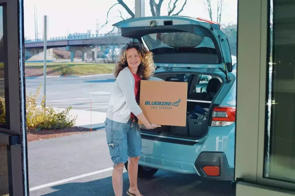 Woman unloading box at Bluebird Self Storage.